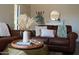 Inviting living room features a leather sofa, stylish decor, and a serene ambiance with natural light, perfect for relaxing at 8787 E Mountain View Rd # 2008, Scottsdale, AZ 85258