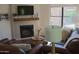 Cozy living room with a fireplace, TV, and comfortable seating at 8787 E Mountain View Rd # 2008, Scottsdale, AZ 85258