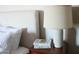 Nightstand with books and lighting next to the bed at 8787 E Mountain View Rd # 2008, Scottsdale, AZ 85258