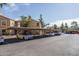 Exterior view of covered parking with multiple cars at the residential community under a clear blue sky at 8787 E Mountain View Rd # 2008, Scottsdale, AZ 85258