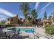 Community pool and hot tub surrounded by lush landscaping and lounge chairs, perfect for relaxation at 8787 E Mountain View Rd # 2008, Scottsdale, AZ 85258