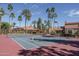Well-maintained tennis court surrounded by lush palm trees, perfect for recreation and outdoor activities at 8787 E Mountain View Rd # 2008, Scottsdale, AZ 85258