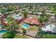 A high angle aerial view shows a red roof home with a pool and well manicured landscaping at 8907 N 85Th Way, Scottsdale, AZ 85258