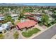 Aerial view of a single-Gathering home with a red tile roof, a pool, mature landscaping, and a green lawn at 8907 N 85Th Way, Scottsdale, AZ 85258