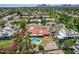 Aerial view of a home with a pool, lush landscaping, and a view of the neighborhood at 8907 N 85Th Way, Scottsdale, AZ 85258
