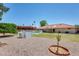 Exterior shot of house with pool, trees, gravel and grass features in the backyard at 8907 N 85Th Way, Scottsdale, AZ 85258