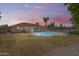 Backyard with a fenced pool, grassy area, and lush landscaping at 8907 N 85Th Way, Scottsdale, AZ 85258