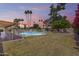 Fenced swimming pool with a covered patio and lush greenery, creating a serene backyard oasis at 8907 N 85Th Way, Scottsdale, AZ 85258
