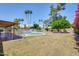 View of backyard with pool, grass and mature landscaping and trees at 8907 N 85Th Way, Scottsdale, AZ 85258