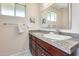 Bathroom featuring a granite countertop vanity, sink, and a large, well-lit mirror at 8907 N 85Th Way, Scottsdale, AZ 85258