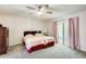 Bedroom featuring two twin beds, carpeted floors, a ceiling fan, and sliding glass doors to the outside at 8907 N 85Th Way, Scottsdale, AZ 85258
