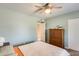 Bright bedroom showcasing neutral walls, ceiling fan, and adjacent bathroom access, enhancing privacy and convenience at 8907 N 85Th Way, Scottsdale, AZ 85258