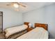 Bright bedroom featuring two twin beds, carpeted floors, and a ceiling fan at 8907 N 85Th Way, Scottsdale, AZ 85258