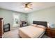 Cozy bedroom with neutral tones, ceiling fan, and an adjacent desk offers a functional and relaxing space at 8907 N 85Th Way, Scottsdale, AZ 85258