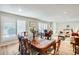 Well-lit dining area featuring an elegant table with seating, plantation shutters, and hardwood floors at 8907 N 85Th Way, Scottsdale, AZ 85258