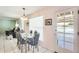 Dining room with a glass top table next to a sliding door leading to a patio at 8907 N 85Th Way, Scottsdale, AZ 85258