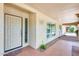 Elegant front door with decorative glass panel, tiled entryway, and stylish exterior lighting at 8907 N 85Th Way, Scottsdale, AZ 85258