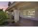 Welcoming front porch with tiled flooring, decorative pillars, and a shuttered window at 8907 N 85Th Way, Scottsdale, AZ 85258
