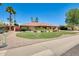 Beautiful front yard featuring vibrant landscaping, a manicured lawn, and a charming single-story home at 8907 N 85Th Way, Scottsdale, AZ 85258