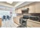 Kitchen with modern appliances and wooden cabinetry overlooking the dining area at 8907 N 85Th Way, Scottsdale, AZ 85258