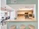 Open kitchen view into the dining area with breakfast bar seating and skylight at 8907 N 85Th Way, Scottsdale, AZ 85258