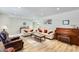 Bright living room featuring hardwood floors, comfortable seating, and a decorative piano at 8907 N 85Th Way, Scottsdale, AZ 85258
