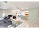 Bright living room featuring a white brick fireplace and casual bar seating connecting to the kitchen at 8907 N 85Th Way, Scottsdale, AZ 85258
