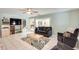 Comfortable living room with tiled flooring, a ceiling fan, and natural light at 8907 N 85Th Way, Scottsdale, AZ 85258