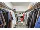 Walk-in closet with shelves, hanging clothes, and carpeting at 8907 N 85Th Way, Scottsdale, AZ 85258