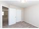 Bedroom featuring carpeted floors, neutral paint, and access to a closet at 9319 W Crown King Rd, Tolleson, AZ 85353