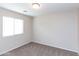 Bright bedroom features neutral carpet, a large window, and fresh, neutral paint at 9319 W Crown King Rd, Tolleson, AZ 85353