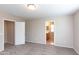 Bedroom featuring carpeted floors and neutral paint leading to a walk-in closet and bathroom at 9319 W Crown King Rd, Tolleson, AZ 85353