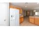 Bright kitchen with tiled flooring, white appliances, and an open view to the living space at 9319 W Crown King Rd, Tolleson, AZ 85353