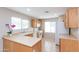 Bright kitchen area with tiled flooring, laminate counters, and white appliances at 9319 W Crown King Rd, Tolleson, AZ 85353