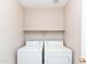 Cozy laundry room with a shelf and white washer and dryer units at 9319 W Crown King Rd, Tolleson, AZ 85353