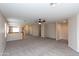Bright living room featuring neutral paint, carpet, and a ceiling fan at 9319 W Crown King Rd, Tolleson, AZ 85353