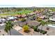 Expansive aerial view of a residential neighborhood with lush green golf course at 9621 E Calgary Ave, Sun Lakes, AZ 85248
