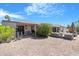 Spacious backyard featuring desert landscaping and covered seating areas at 9621 E Calgary Ave, Sun Lakes, AZ 85248
