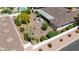 Bird's-eye view of a desert backyard with a covered patio and a pool nearby at 9621 E Calgary Ave, Sun Lakes, AZ 85248