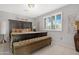 Comfortable bedroom with large bed, bench, shuttered window, and gray walls at 9621 E Calgary Ave, Sun Lakes, AZ 85248