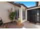 Close-up of a front entrance featuring a security door and decorative landscaping at 9621 E Calgary Ave, Sun Lakes, AZ 85248