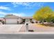 Charming single-story home featuring a well-manicured front yard and a two-car garage at 9621 E Calgary Ave, Sun Lakes, AZ 85248