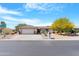 Charming single-story home featuring a well-manicured front yard and a two-car garage at 9621 E Calgary Ave, Sun Lakes, AZ 85248