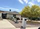 Charming home exterior with desert landscaping, rock mulch, and mature desert foliage at 9621 E Calgary Ave, Sun Lakes, AZ 85248