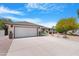Charming single-story home featuring a well-manicured front yard and a two-car garage at 9621 E Calgary Ave, Sun Lakes, AZ 85248