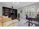 Home office with an expansive bookcase, desk, and comfortable sofa at 9621 E Calgary Ave, Sun Lakes, AZ 85248