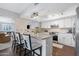 Bright kitchen featuring white cabinets, granite countertops, an island, and stainless steel appliances at 9621 E Calgary Ave, Sun Lakes, AZ 85248