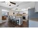 Bright kitchen with white cabinets, granite countertops, island with seating, and stainless steel appliances at 9621 E Calgary Ave, Sun Lakes, AZ 85248