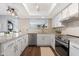Well-lit kitchen featuring granite countertops, stainless steel appliances and bright white cabinets at 9621 E Calgary Ave, Sun Lakes, AZ 85248