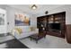 Living room with built-in shelves, white couch, and natural light at 9621 E Calgary Ave, Sun Lakes, AZ 85248